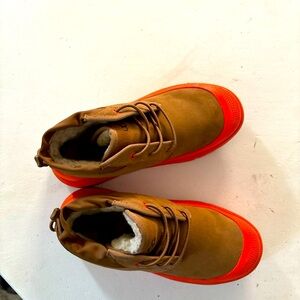 Chestnut color men uggs with orange trim.
